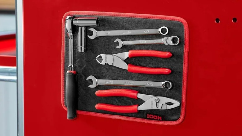 A magnetic Icon tool mat attached to a red metal surface