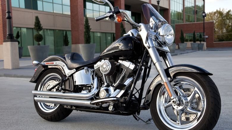 A Harley-Davidson Fat Boy is parked outside an office complex