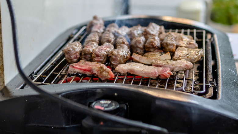 Meat being cooked on an electric grill