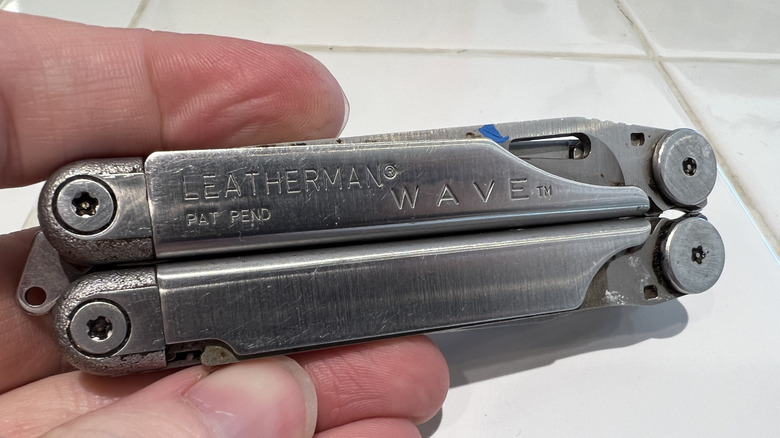 Hand holding Leatherman tool.