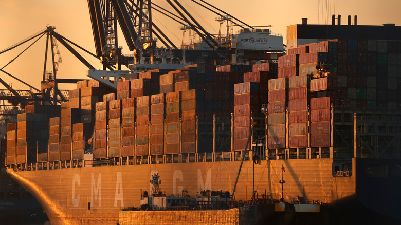 A large cargo ship with rows of containers on board.