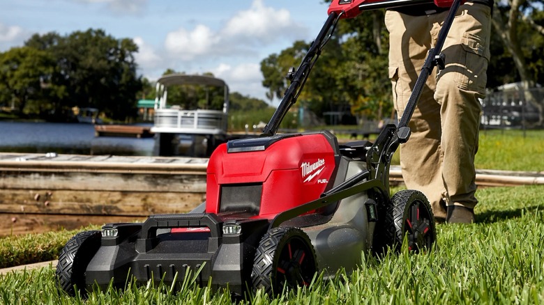 A person using a Milwaukee lawn mower.