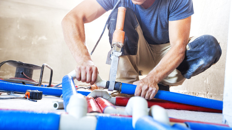 Plumber welding plastic pipes