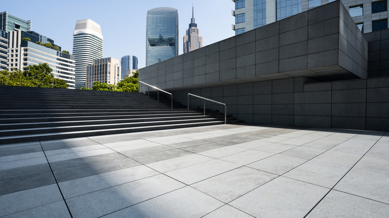 a pavement with high rise buildings in the background
