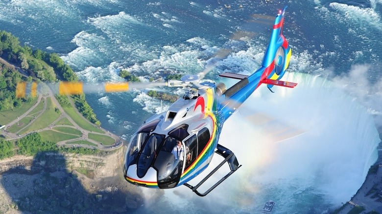 An Airbus H130 helicoper flying above the Niagara Falls.