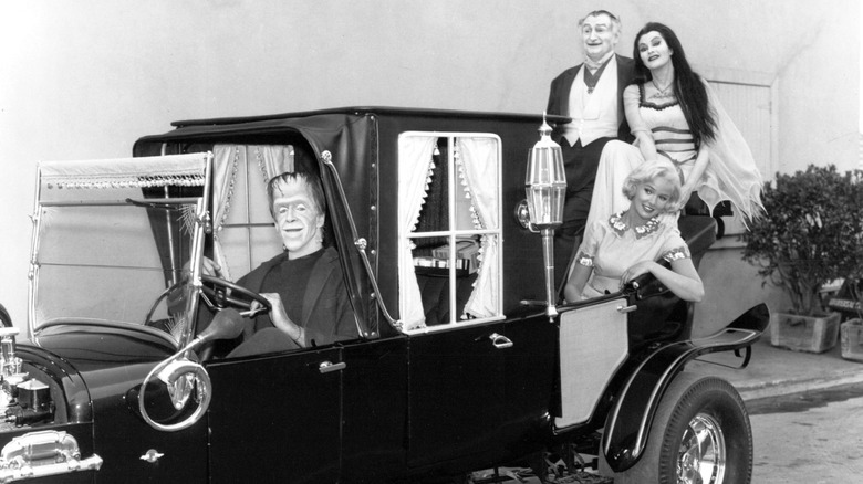 Photo of the cast of The Munsters sitting in the Munster Koach