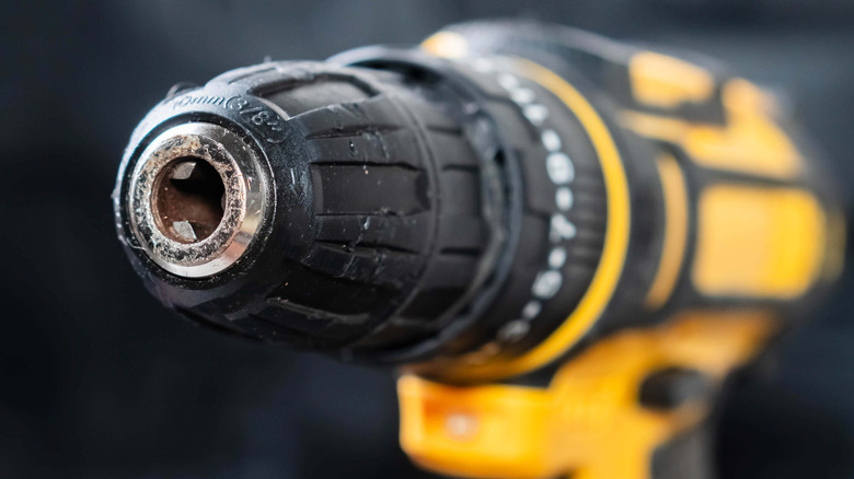 The front of a black and yellow power drill.