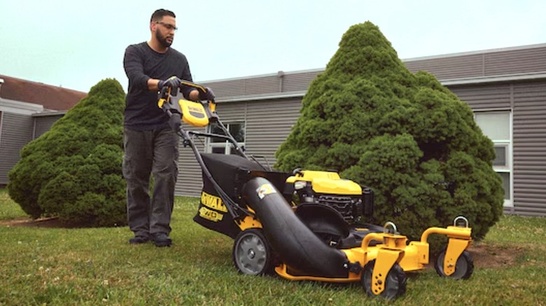 Person using DeWalt's 28-inch 3-in-1 Lawn Mower
