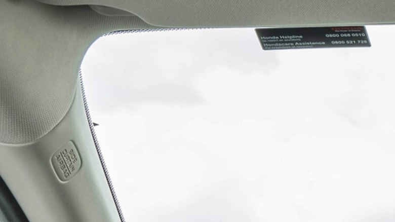 A close-up of the inside of a Honda ZR-V Advance's windscreen, clearing showing a triangle on the corner.