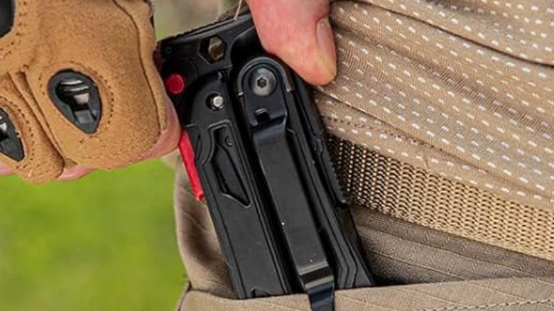 Person placing Wetols 27-in-1 multi-tool in pocket