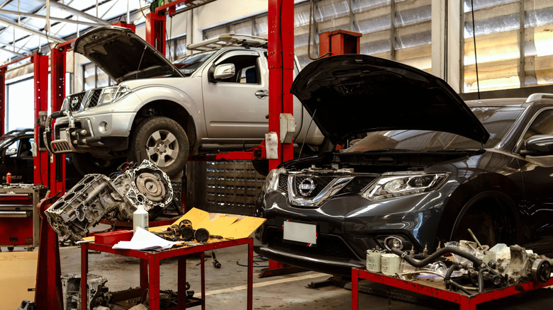 Two Nissans in a workshop