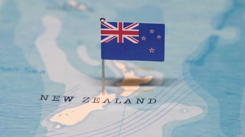 New Zealand flag on a map of New Zealand.
