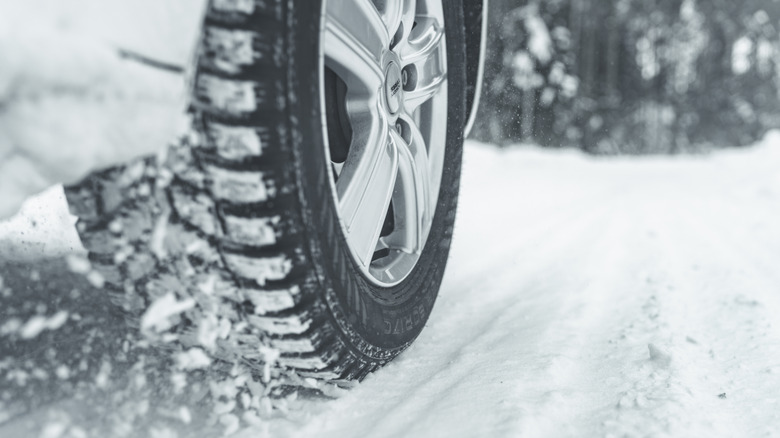 Snow tire on car in snowy conditions