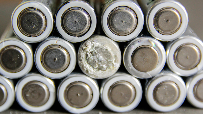 A leaking battery stacked between other batteries.
