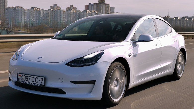 Tesla Model 3 driving down a highway