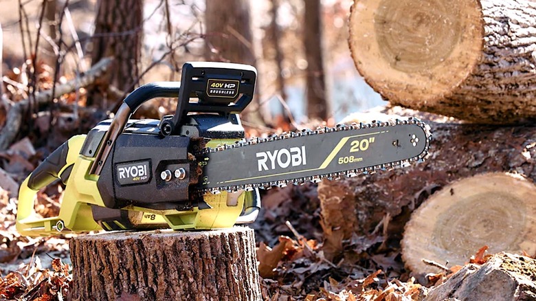 Ryobi chain saw resting on top of a tree stump