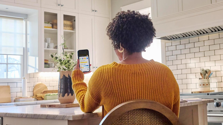 a woman uses the hubspace app on her phone