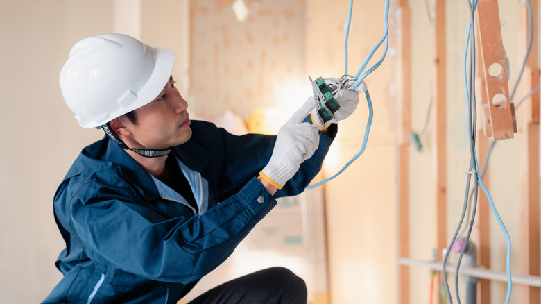 Electrician working on wires at a construction site