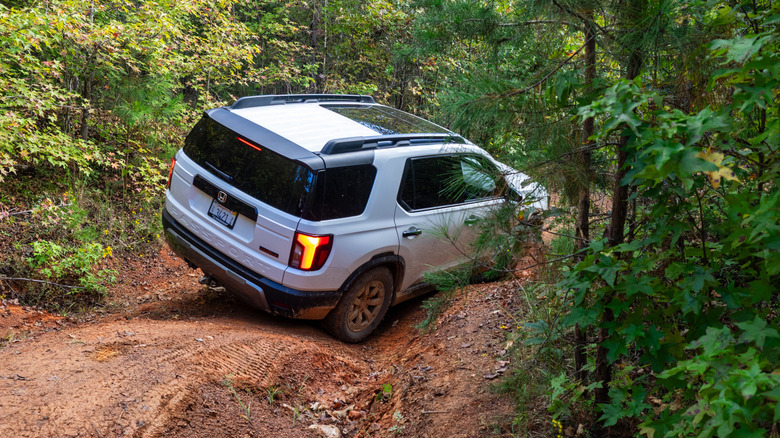2026 Honda Passport TrailSport descending down a rough, red clay trail