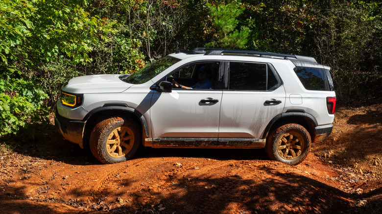2026 Honda Passport TrailSport navigating a rough, red clay trail