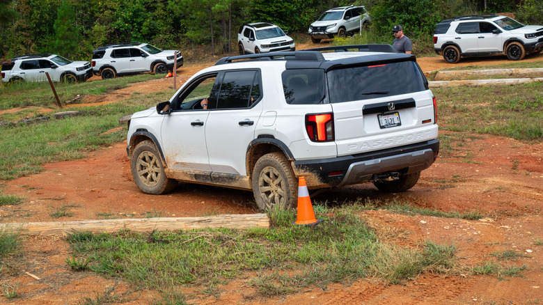 A 2026 Honda Passport TrailSport Elite goes through an obstacle course while other Passports wait their turn