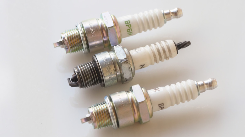 Three different spark plugs lined up