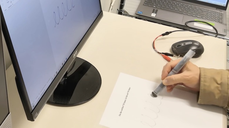 Person using a magentic pen.