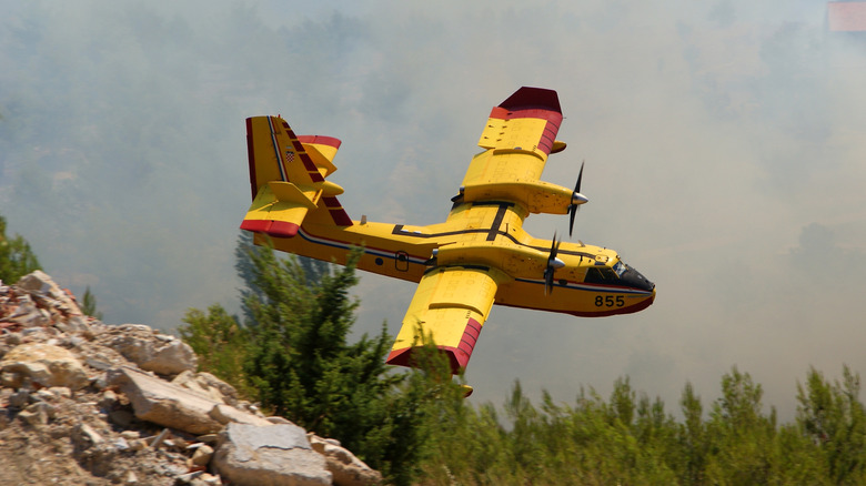 CL 415 Super Scooper plane flying in mountains
