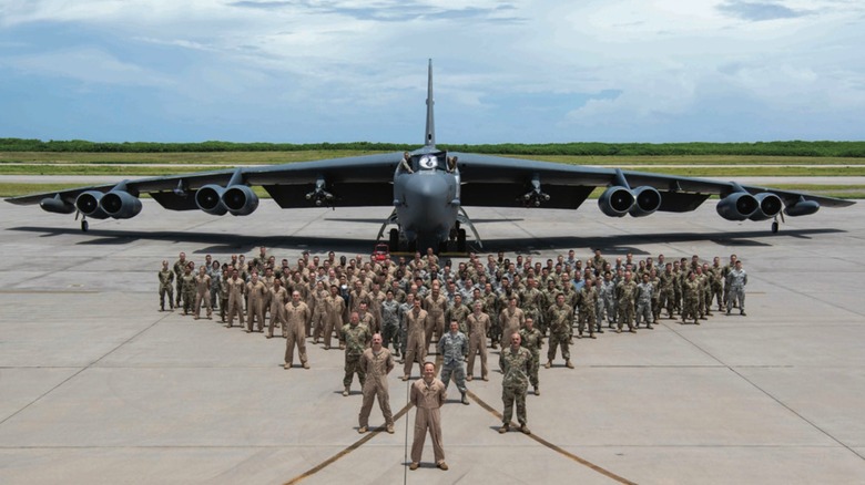 B-52 crew stand in front of aircraft in 