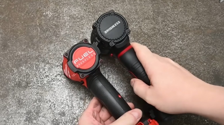 Hands holding Milwaukee M18 Fuel Surge and Hyper Tough hydraulic impact drivers side by side