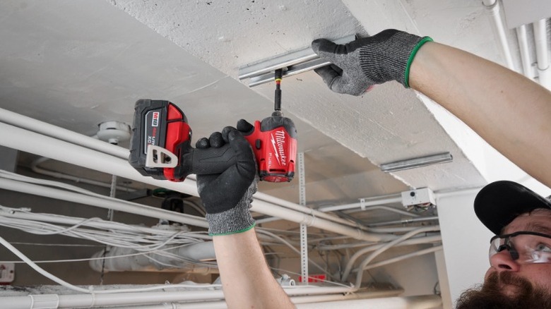 Person using Milwaukee M18 Fuel Surge impact driver