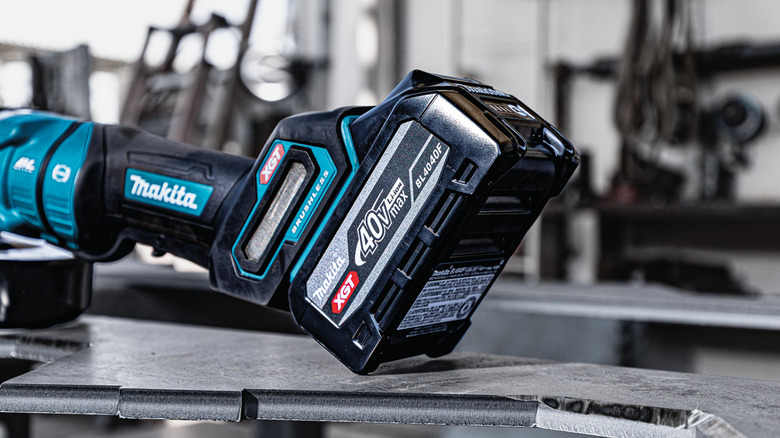 Makita 40V max XGT 4Ah high power battery connected to a tool in a workshop