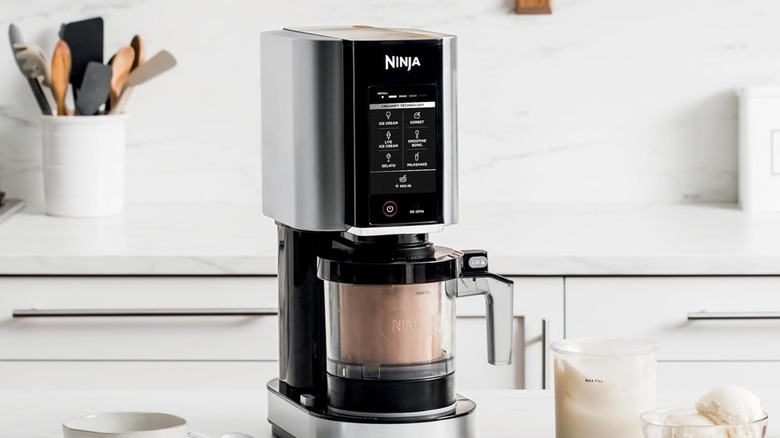 Ninja Creami on countertop mixing chocolate base