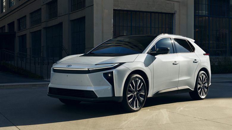 White 2026 Toyota bZ parked in front of building.