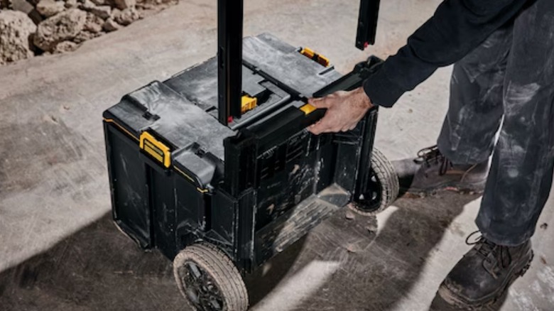 a person with a dewalt toughsystem rolling modular toolbox