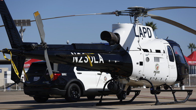LAPD helicopter parked on concrete beside police suv