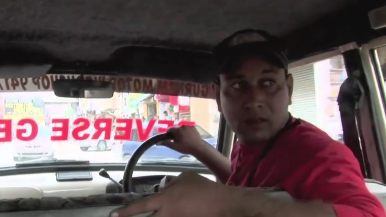 Harpeet Devin driving his Fiat Padmini in reverese on the streets of Punjab, India.
