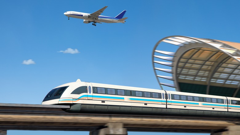 Shanhai maglev train leaving a station with a commercial jet in the background
