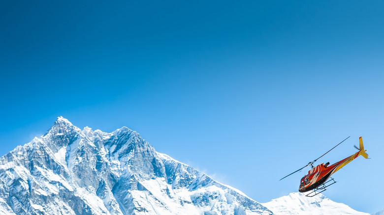Helicopter flying over mountains