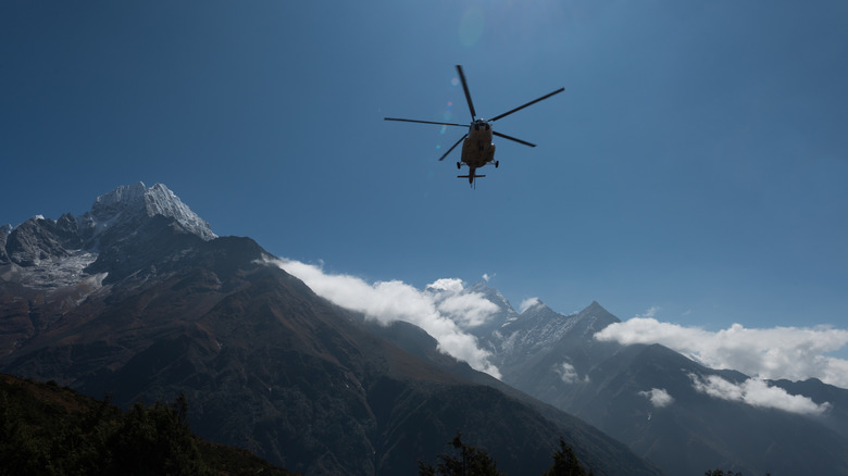 Front view of helicopter over mountains