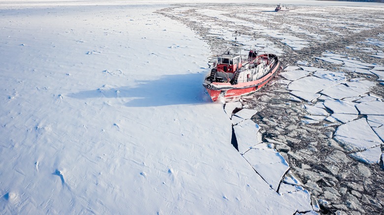 Icebreaker ship cutting through sea ice
