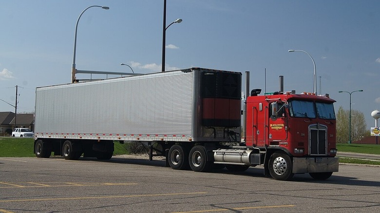 Kenworth cabover semi truck and trailer.