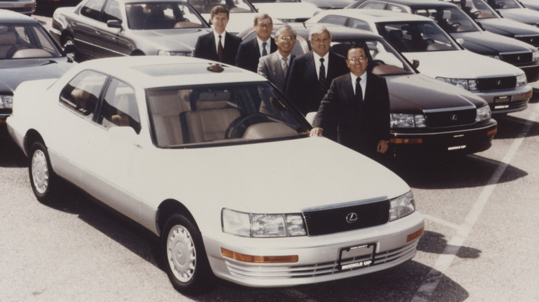 White 1990 Lexus LS400 parked with company representatives