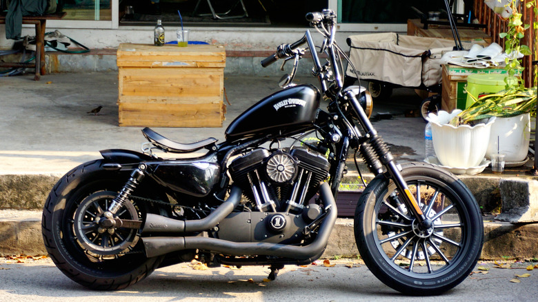 A Harley-Davidson parked in a street, side view