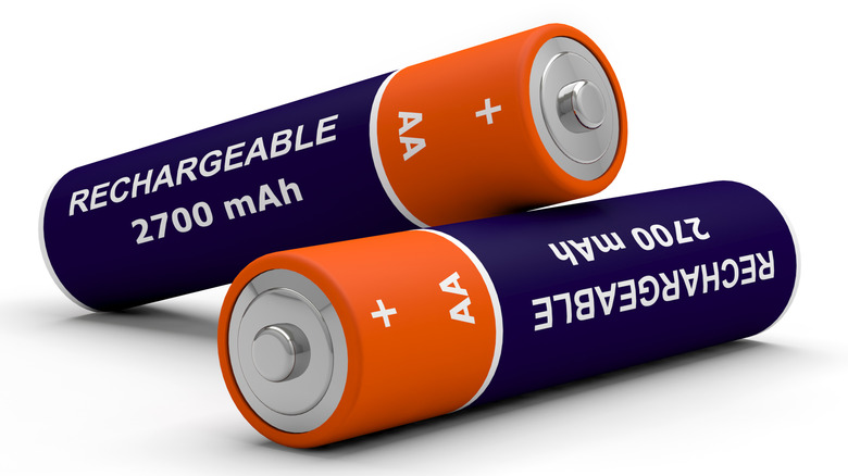 Two rechargeable batteries on a white surface. The second battery is resting on the first. They are dark blue and orange in color and display the words "Rechargeable 2700 mAh AA"