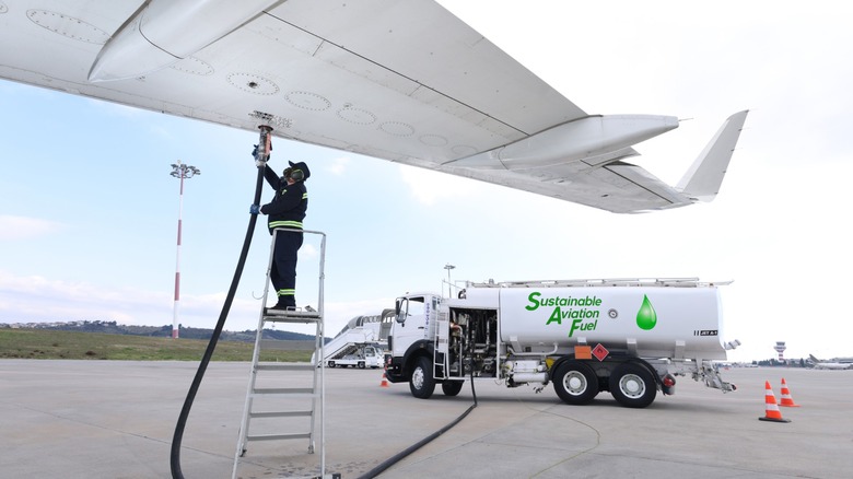 Someone refueling an aircraft with sustainable aviation fuel