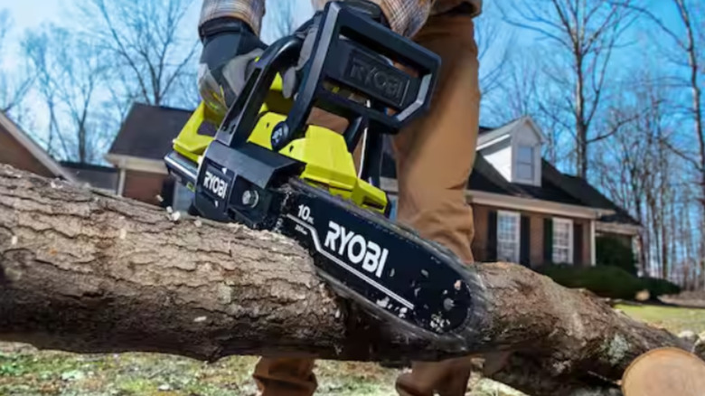 A man using the Ryobi 40V chainsaw