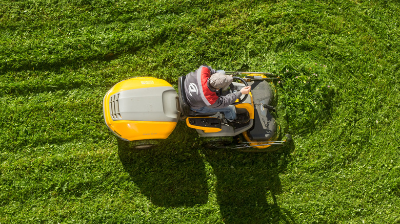 Overhead shot of a man using a riding lawn mower