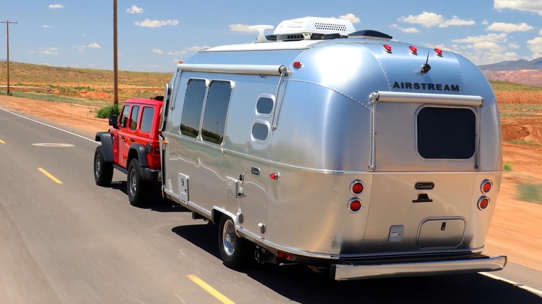2024 Jeep Wrangler Rubicon towing an Airstream travel trailer in the desert