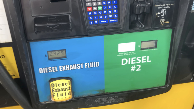 a def pump next to a diesel pump at a gas station